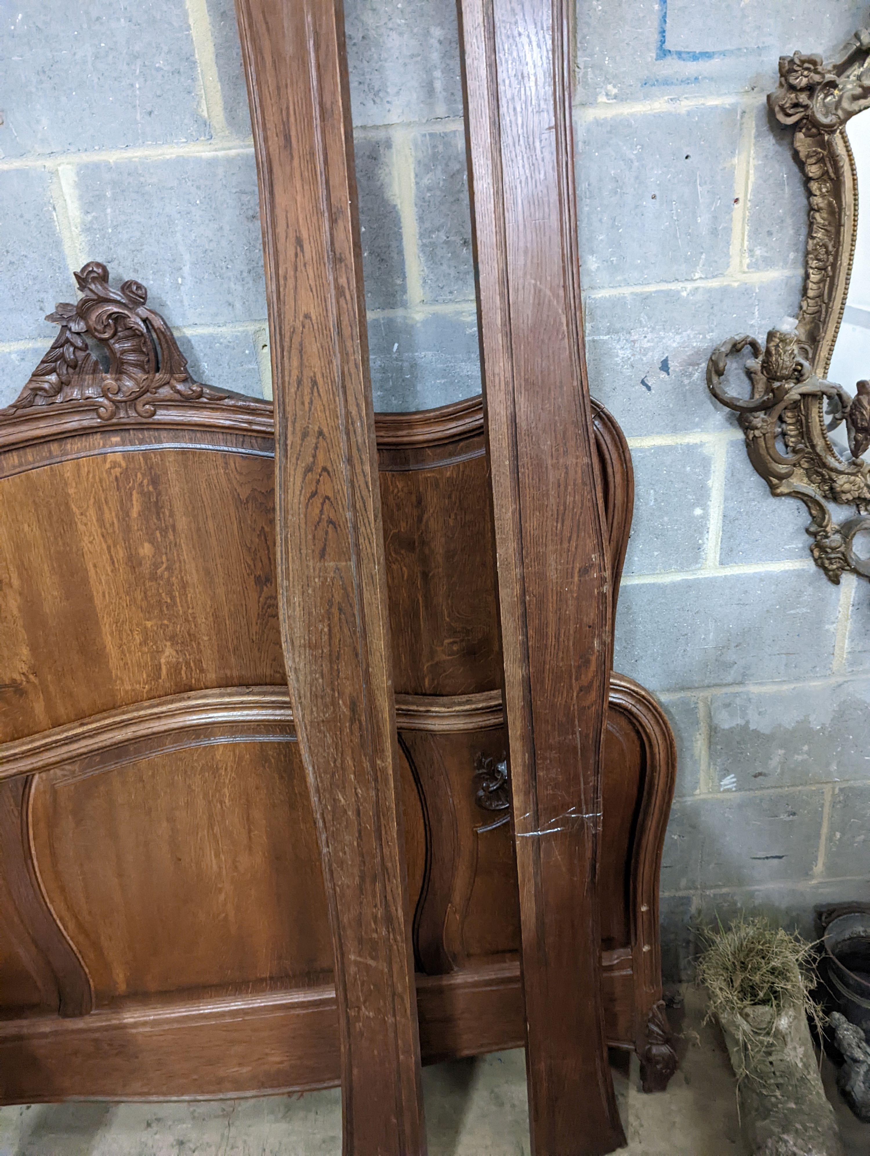 A late 19th century French oak bed frame, no bolts, width 140cm